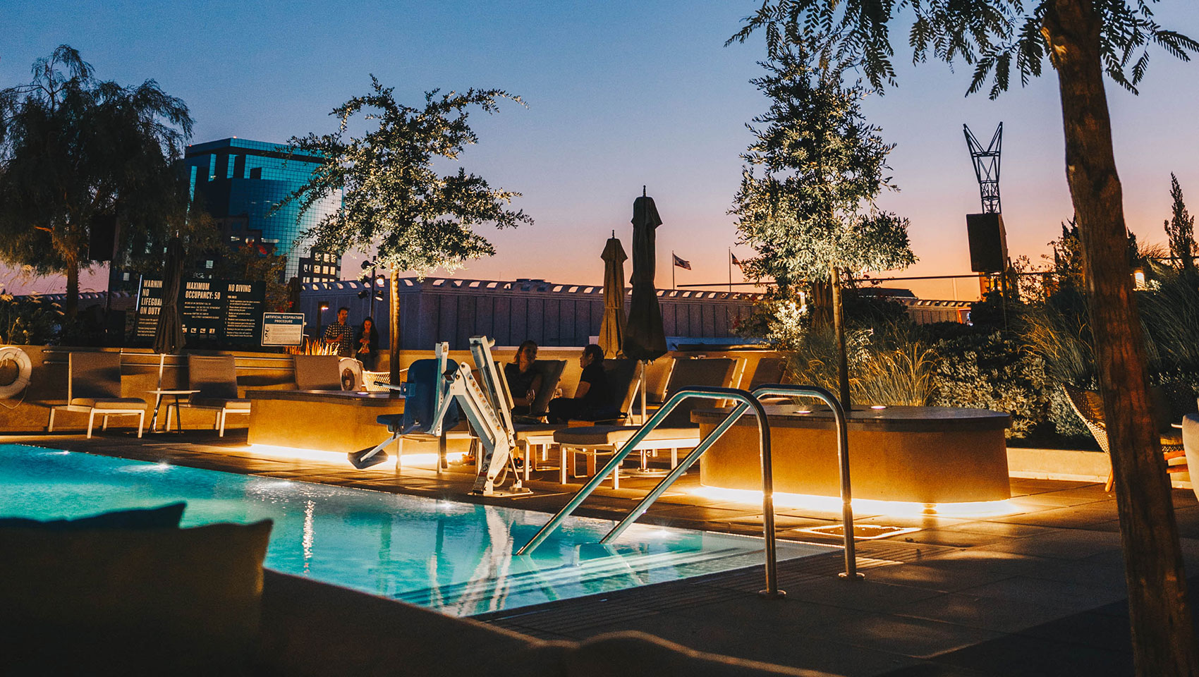 Sawyer Rooftop Pool seating at sundown