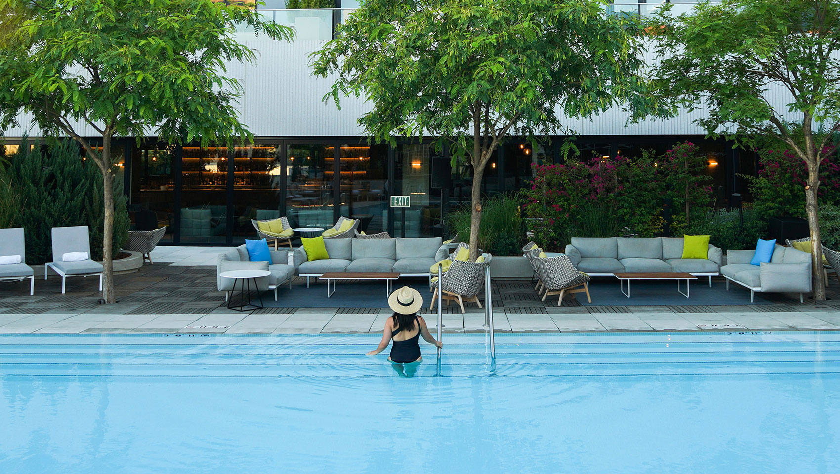 Woman standing at the stairs of the hotel pool