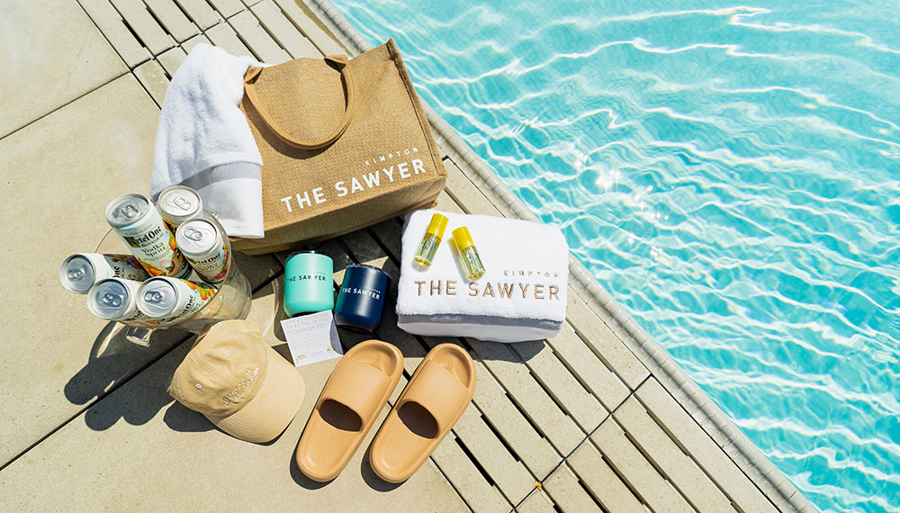 Sawyer Pool bag with content on deck next to pool