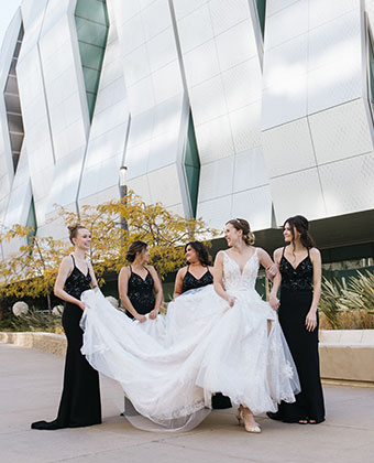 bride and bridesmaids in wedding dresses outside of hotel