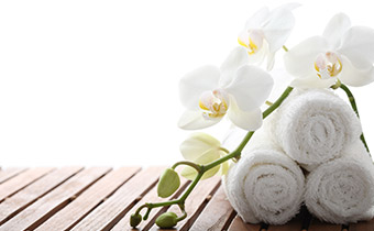 rolled towels on a spa bench
