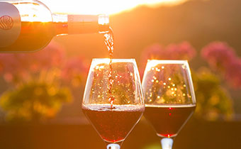 wine being poured into glasses overlooking garden