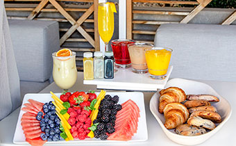 Fruit tray, pastries, mimosa, mocktail and wellness shots
