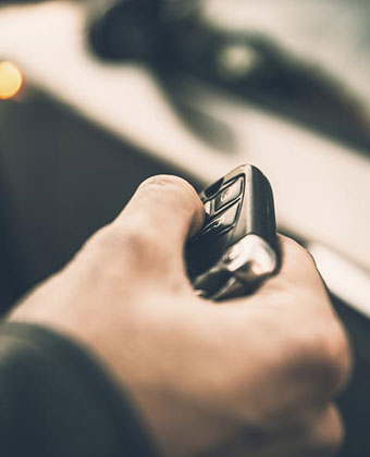man's hand holding car key remote